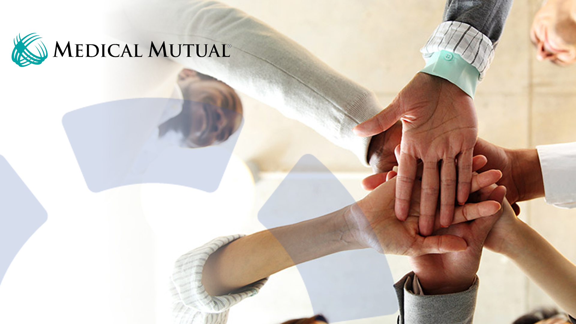 five sets of hands form in the middle of a circle for a team cheer