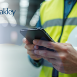 person holding a hard hat while scanning the BWC website on a mobile device