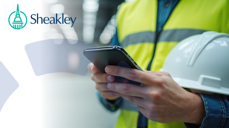 person holding a hard hat while scanning the BWC website on a mobile device