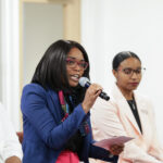 4 Women Speaking in front of an audience
