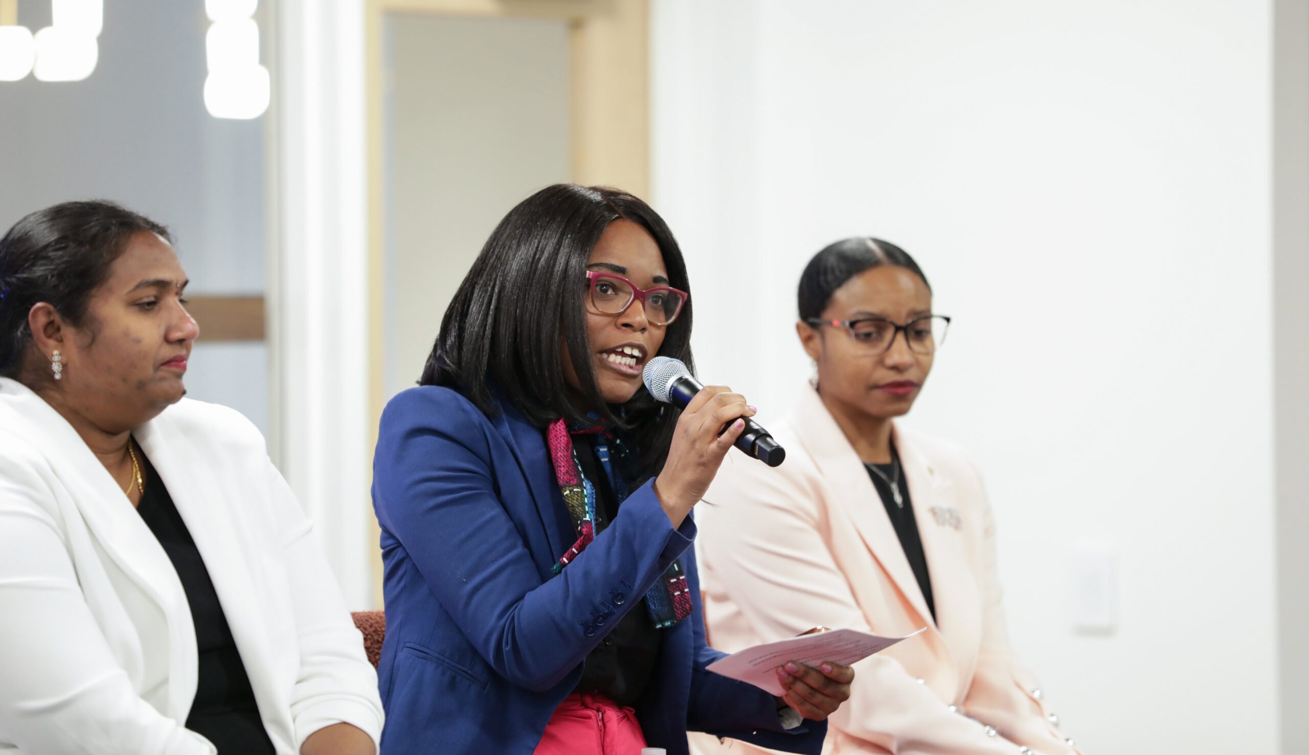 4 Women Speaking in front of an audience